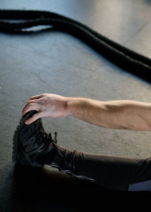 Detailed close-up of dynamic stretching focus on leg flexibility.